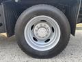 Close-up of a wheel on a 2009 Ford F-550 featuring a silver rim with multiple bolts and a large black tire displaying tread patterns