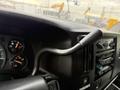 The interior dashboard of a 2004 Chevrolet Express featuring gauges for speed and fuel with a gear shift lever prominently displayed
