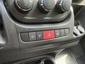 Interior dashboard controls of a 2021 RAM Promaster including temperature knobs and various buttons for lights and hazard signals