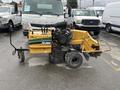 A 2014 Vermeer Corporation Sweep Stump Cutter with a black engine a yellow frame and large wheels designed for grinding tree stumps