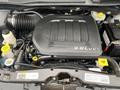 The image shows the engine compartment of a 2014 RAM Cargo Van with a dark engine cover labeled 3.6L VVT and various components including hoses and fluid reservoirs
