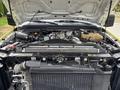 Engine compartment of a 2010 Ford F-550 Super Duty showing the engine and surrounding components with the hood lifted