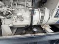 A 2005 Katolight SED60FPJ4 generator with a light-colored exterior featuring multiple pipes and hoses connected to a large engine and a noticeable fan guard