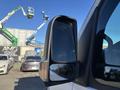 A 2024 Mercedes-Benz Sprinter 2500 side mirror reflecting light with a clear view of its sleek design and integrated turn signal