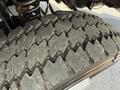 Close-up of a large tire showcasing deep treads and rugged surface on a vehicle designed for heavy-duty use