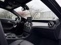 Interior of a 2016 Mercedes-Benz GLA-250 featuring a dashboard with a central display touchscreen and circular air vents