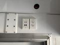 A panel featuring electrical outlets including standard and inverter plugs mounted on a smooth surface