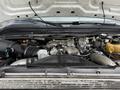 A 2008 Ford F-550 engine with various components including turbocharger and hoses visible under the hood