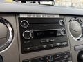 Dashboard controls of a 2019 Ford F-750 featuring a radio display with various buttons and knobs for audio settings and volume adjustment