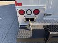 A 2008 International 4400 with a silver rear bumper featuring red and white lights and a metal hitch attachment