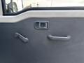 Interior door panel of a 2010 Daihatsu Hijet featuring a manual window crank and a door handle