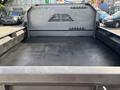 Interior of a 2013 RAM 5500 truck bed showing a clean black surface with metal walls and no visible cargo or items