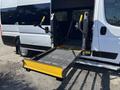 A 2020 RAM ProMaster 3500 van with an extended wheelchair lift platform in the open doorway