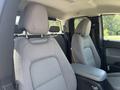 Interior view of a 2017 Chevrolet Colorado showcasing two front seats with fabric upholstery and adjustable headrests