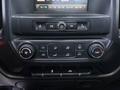 The interior dashboard controls of a 2017 GMC Sierra 3500HD featuring climate control buttons and an infotainment display