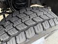 Close-up of a treaded tire on a 2020 Ford F-550 showcasing its deep grooves and robust rubber design