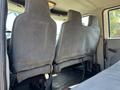 Interior view of a 2011 International 4300 showing two gray upholstered seats in the foreground with visible wear