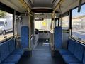 Interior of a 2016 Grande West Vicinity bus featuring blue upholstered seating and a driver's area at the front with controls and a steering wheel