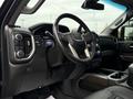 Interior view of a 2022 GMC Sierra 3500HD featuring a modern dashboard with touchscreen display and a leather-wrapped steering wheel