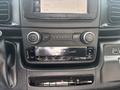 Dashboard controls of a 2023 RAM Promaster 3500 featuring audio and climate controls with a central display screen