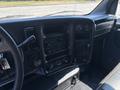 Interior view of a 2005 GMC C7500 Topkick dashboard featuring controls gauges and a stereo system with visible buttons and knobs