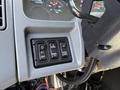 Control panel with four buttons for illumination and work lights on the dashboard of a 2006 International 7500 truck