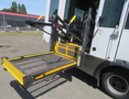 A 2020 Chevrolet Express with an extended wheelchair ramp in the lowered position