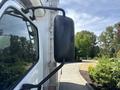 A side view mirror of a 2018 Hino 195 truck with a black, rounded casing mounted on a metal arm