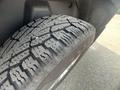 Close-up of a rugged tire mounted on a 2015 RAM 1500 showing deep treads designed for off-road traction and performance