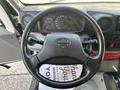 Steering wheel of a 2018 Hino 195 with dashboard gauges and controls visible