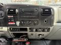 Dashboard of a 2007 Ford F-450 featuring a radio climate controls and various switches with wiring visible beneath the dashboard