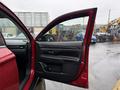 A 2016 Mitsubishi Outlander with the driver's side door open displaying the interior door panel and controls