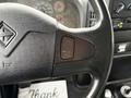 Close-up of the steering wheel of a 2006 International 4200 showing a button labeled "SET CANCEL" and "RESUME ACCEL" on the left side of the wheel