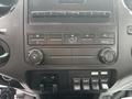 Dashboard of a 2014 Ford F-550 featuring climate control knobs and switches for auxiliary functions