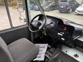 Interior view of a 2012 Ford E-450 Super Duty with a driver's seat steering wheel and dashboard controls visible