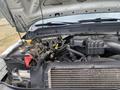 A 2014 Ford F-350 SD with the hood lifted showing the engine compartment including various components and wiring
