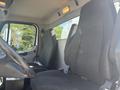 Interior of a 2022 Freightliner M2 106 showing two black upholstered seats and part of the steering wheel