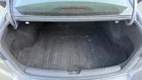 A spacious trunk of a 2018 Hyundai Sonata with a black carpet interior and no contents visible