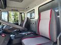Interior of a 1994 Volvo FE 42 showing two gray seats with red accents and the driver's cockpit with controls and gear shift