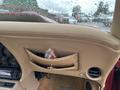 Interior view of a 1970 Chevrolet Corvette showing beige upholstery storage pocket and dashboard with gauges and audio system