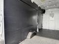 Interior of a 2021 Ford Transit cargo van featuring a flat black wall panel and a heightened rear area for storage
