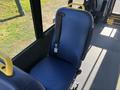 A blue seat with a yellow handle inside a 2017 Ford Transit-350 passenger area