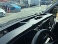 Interior dashboard of a 2025 Ford Transit T-350 featuring controls and storage compartments