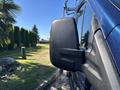 Close-up of the side mirror of a 2016 Ford Transit 150 with a black casing and slight reflections on the surface