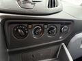 Interior control panel of a 2017 Ford Transit featuring dials for climate control fan speed temperature and air conditioning along with a 12V power outlet