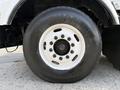 Close-up of a white wheel and tire from a 1996 Kenworth T800 with prominent black tread and visible metallic lug nuts