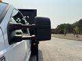 A 2009 Ford F-450 Super Duty truck with a prominent side mirror in focus