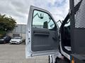 The image shows the open driver side door of a 2018 Ford F-750 with a gray interior handle and a clear view inside the cabin