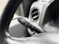 Close-up of a 2013 Ford E-350 steering column with a windshield wiper control lever and other dashboard controls visible