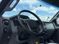 Interior view of a 2017 Ford F-750 truck featuring a steering wheel dashboard and gear shift